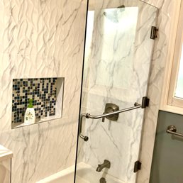 New bathtub, shower, glass, and tile