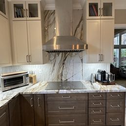 New cabinets, induction cooktop, hood, countertops and backsplash.