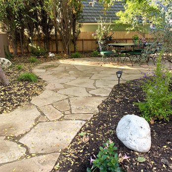 Alexander's Landscaping - Mandevilla, skyflower, flagstone paths - Landscaping Near Me