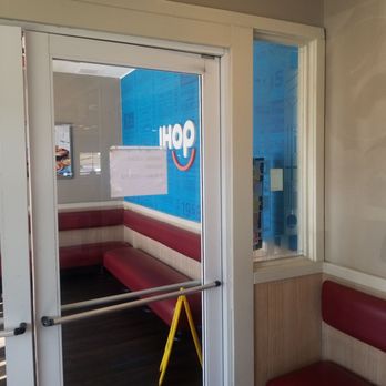 IHOP - the reflection of a sign on the door - American Near Me - Stone Mountain, Georgia