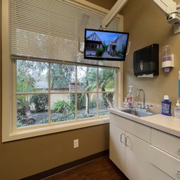 Clean spacious patient room with large window and television Clean spacious patient room with large window and television