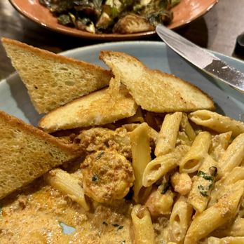 Busboys and Poets - Cajun shrimp and sausage pasta and Brussels sprouts. - Vegan Near Me - Washington, DC, District of Columbia