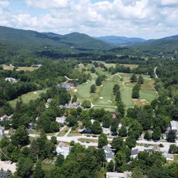 Dorset Union Store - Drone photo of town of Dorset with lush trees, rolling green mountains and green grass