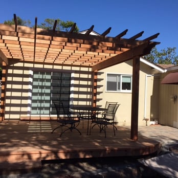 PR Woodworks - a pergolated patio with a table and chairs - General Contractors Near Me PR Woodworks - a pergolated patio with a table and chairs - General Contractors Near Me