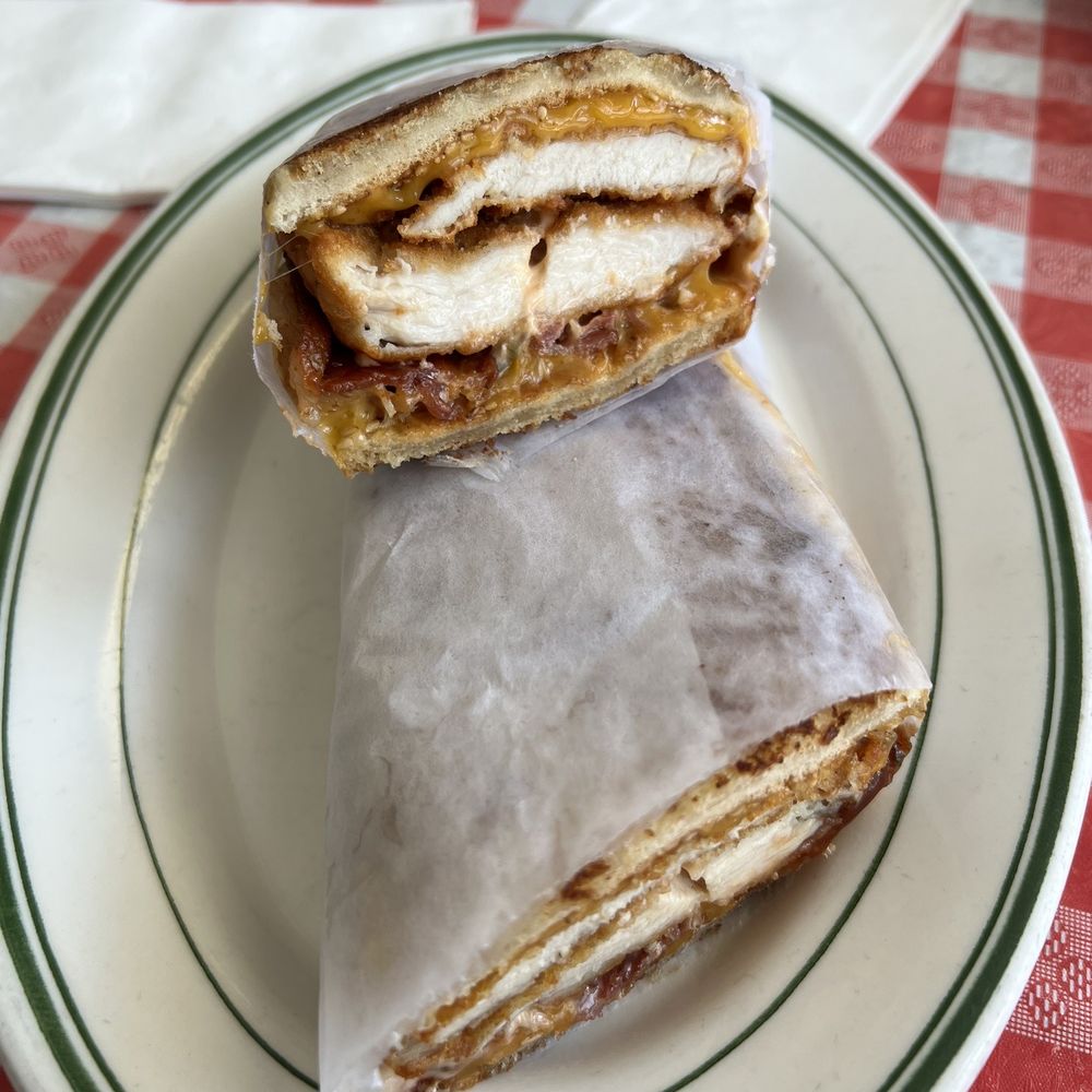 Breaded chicken cutlet panini, cheddar cheese, bacon, thousand island, and bbq sauce Breaded chicken cutlet panini, cheddar cheese, bacon, thousand island, and bbq sauce