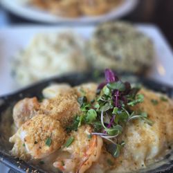Seafood bake with shrimp, scallops, and haddock topped with butter and bread crumbs. Delightful!