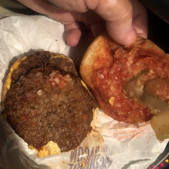McDonald's - a hand grabbing a hamburger from a wrapper - Coffee & Tea Near Me - St. Petersburg, Florida McDonald's - a hand grabbing a hamburger from a wrapper - Coffee & Tea Near Me - St. Petersburg, Florida
