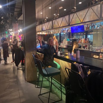 Moxy Minneapolis Uptown - Fun at the bar with new friends - Hotels Near Me - Minneapolis, Minnesota
