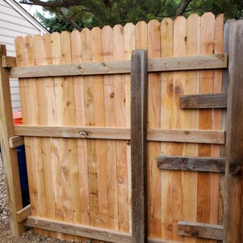 Martin And Sons - a wooden fence and a trash can - Handyman Near Me Martin And Sons - a wooden fence and a trash can - Handyman Near Me