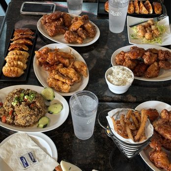 Bonchon Woodlawn - Whole table of all the food we ordered! Minus the minor cutoff of the pork buns. - Korean Near Me - Charlotte, North Carolina