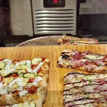 Apizza Alimentari - Precut slices waiting to be reheated - Italian Near Me - Fayetteville, New York Apizza Alimentari - Precut slices waiting to be reheated - Italian Near Me - Fayetteville, New York