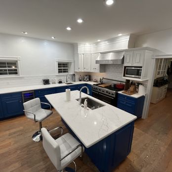 Aureum Carpentry - a large kitchen with blue cabinets - Carpenters Near Me