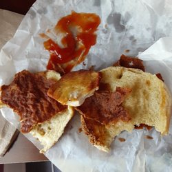 Terrible chicken sandwich with small piece of meat hiding inside a large burnt chicken breading coating that stuck to the top bun