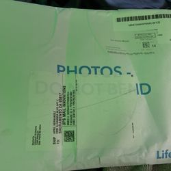 US Post Office - Bent photos that says "photos do not bend" on the envelope.