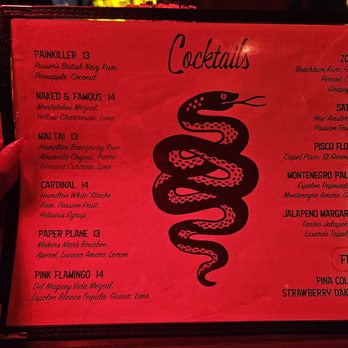 Zig Zag - Drink menu - A cocktail menu printed on red paper features a black snake illustration and lists various drinks with prices, including tropical and frozen cocktails. - Cocktail Bars Near Me - Brooklyn, New York