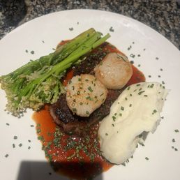 Steak, scallops with mash potatoes and broccolini
