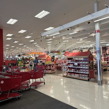 Target - The image shows the interior of a Target store in Clearwater, FL, featuring bright lighting, holiday-themed display stands, and shopping carts near the entrance. Customers are browsing the aisles, and the store has a clean, organized appearance with various products on display. - Department Stores Near Me - Clearwater, Florida