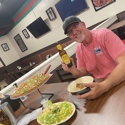 My honey enjoying his beer and pizza My honey enjoying his beer and pizza