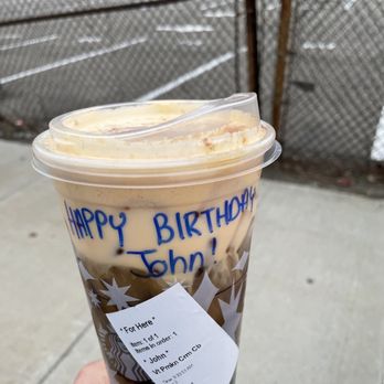Starbucks - a hand holding a cup of iced coffee - Coffee & Tea Near Me - Rego Park, New York Starbucks - a hand holding a cup of iced coffee - Coffee & Tea Near Me - Rego Park, New York