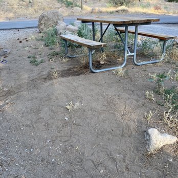 Flagstaff KOA - Table on a dirt hill with nothing but weeds under it. - RV Parks Near Me - Flagstaff, Arizona