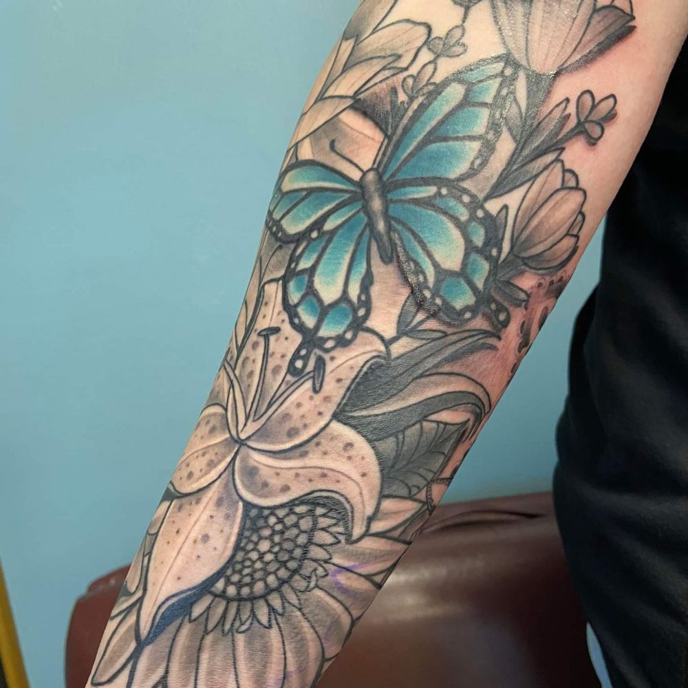 Anomaly Tattoo Studio - Close up front of arm. Flowers and butterfly - Tattoo Near Me - Modesto, California Anomaly Tattoo Studio - Close up front of arm. Flowers and butterfly - Tattoo Near Me - Modesto, California