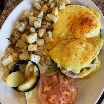 Le Peep - My husband had already cut the eggs Benedict in half but here is a lovely breakfast with their potatoes and some stewed apples. - Breakfast & Brunch Near Me - Meridian, Idaho