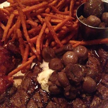 Saltgrass Steak House - Medium rare ribeye with mushroom topping, sweet potato fries, and stuffed shrimp - Steakhouses Near Me - Webster, Texas
