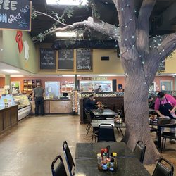 Abe's Cajun Market & Cafe - Interior seating and a massive fake tree