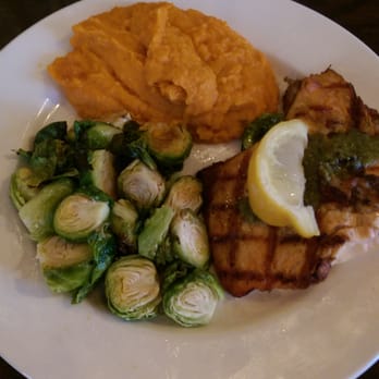 Not Your Average Joe's - Glen Mills - Sage Pecan Salmon - Grilled and topped with a sage pecan pesto, chipotle mashed sweet potatoes and roasted brussels sprouts - Burgers Near Me - Glen Mills, Pennsylvania Not Your Average Joe's - Glen Mills - Sage Pecan Salmon - Grilled and topped with a sage pecan pesto, chipotle mashed sweet potatoes and roasted brussels sprouts - Burgers Near Me - Glen Mills, Pennsylvania