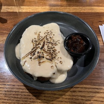 Hawk & Griffin - Welsh rarebit what looks like a hollandaise sauce with cheese mixed in on a piece of robust toast and a Branston pickle side - Pubs Near Me - Vienna, Virginia
