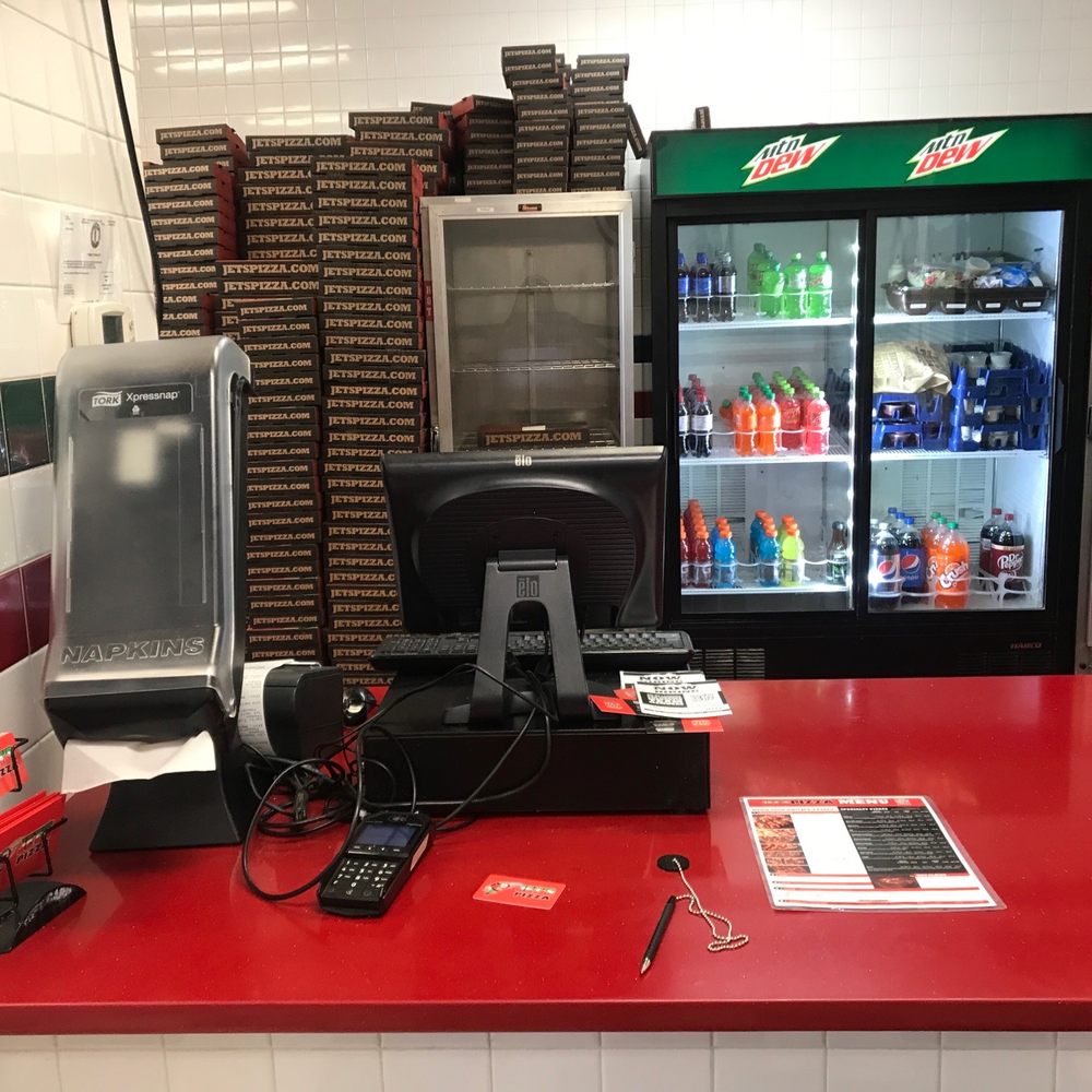 a counter with a phone and a vending machine a counter with a phone and a vending machine