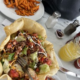 Taco salad, sweet potato fries and a mimosa. Taco salad, sweet potato fries and a mimosa.