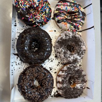 Duck Donuts - Left - Chocolate Sprinkles & Hot Fudge Drizzle, Midnight Madness, Chocolate Explosion Right - Beach Ball, The Boardwalk, Cookies & Cream - Donuts Near Me - Brandon, Florida