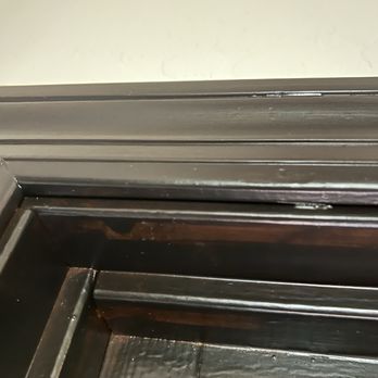 Jimenez Refinishing Llc - Front door stain uneven - A dark wooden cabinet corner with visible uneven stain and minor scratches, showing signs of wear and tear. - Refinishing Services Near Me