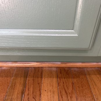 A1 Paintings - White spots from spray primer on moulding and floor. - Painters Near Me