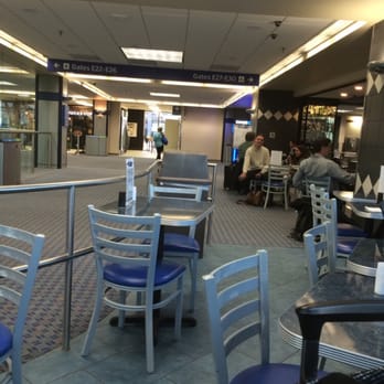 Fly Bar - people sitting at tables in an airport - American Near Me - Irving, Texas