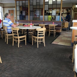 people sitting at tables in a restaurant