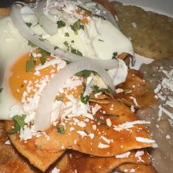 Mi Casa Su Casa - Red Chilaquiles with eggs , beans and a side of hash brown
