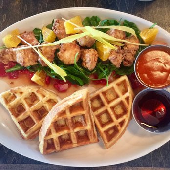Commoner & Co - Corn waffles, spicy chicken bites & maple syrup. Tasty arugula salad, quartered oranges, 3 types watermelon & honey lemon dressing - Cocktail Bars Near Me - Tucson, Arizona
