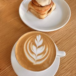 Reve Coffee Lab - Cappuccino and cinnamon roll with espresso glaze.