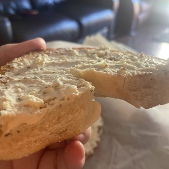 Sonoma Valley Bagel - a hand holding a bagel with a bite taken out of it - Coffee & Tea Near Me - Rohnert Park, California Sonoma Valley Bagel - a hand holding a bagel with a bite taken out of it - Coffee & Tea Near Me - Rohnert Park, California