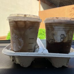 two cups of iced coffee on a tray two cups of iced coffee on a tray