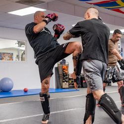 Kickboxing class focused on Muay Thai and Dutch-style striking, where students practice footwork, combos, and controlled spar...