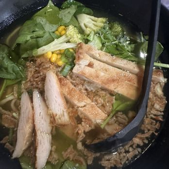 Fun Noodle Bar - 34. Chicken Fun Ramen - A bowl of ramen featuring sliced chicken, beef, leafy greens, corn, and broth, served in a black bowl. - Chinese Near Me - Santa Fe, New Mexico