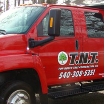 TNT Contracting - a red truck parked in front of a house - Tree Services Near Me - Warrenton, Virginia
