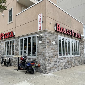 Rosa's Pizza - a motorcycle parked in front of a restaurant - Pizza Near Me - Astoria, New York Rosa's Pizza - a motorcycle parked in front of a restaurant - Pizza Near Me - Astoria, New York