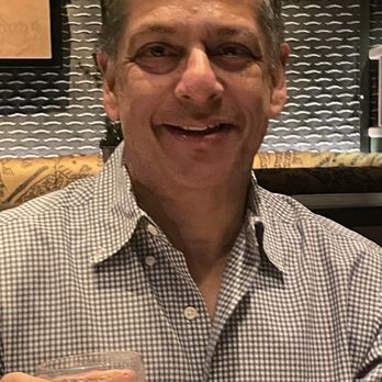 Spygold - a man holding a glass of wine - Cocktail Bars Near Me - New York, New York Spygold - a man holding a glass of wine - Cocktail Bars Near Me - New York, New York