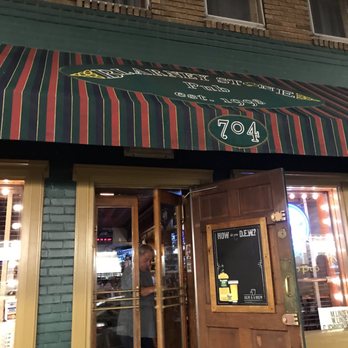 Blarney Stone Pub - Entrance - A pub entrance features a striped awning with the address 704, and a person is visible inside near the door, which is partially open. - Pubs Near Me - Baltimore, Maryland