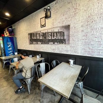 Local Bagel Co. - a man sitting at a table - Bagels Near Me - Hauppauge, New York