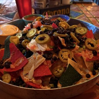 Julio's Barrio Mexican Restaurant - The Mucho Macho Nachos are good to share between 4 people. Adding chicken/beef is extra! - Mexican Near Me - Edmonton, Alberta Julio's Barrio Mexican Restaurant - The Mucho Macho Nachos are good to share between 4 people. Adding chicken/beef is extra! - Mexican Near Me - Edmonton, Alberta